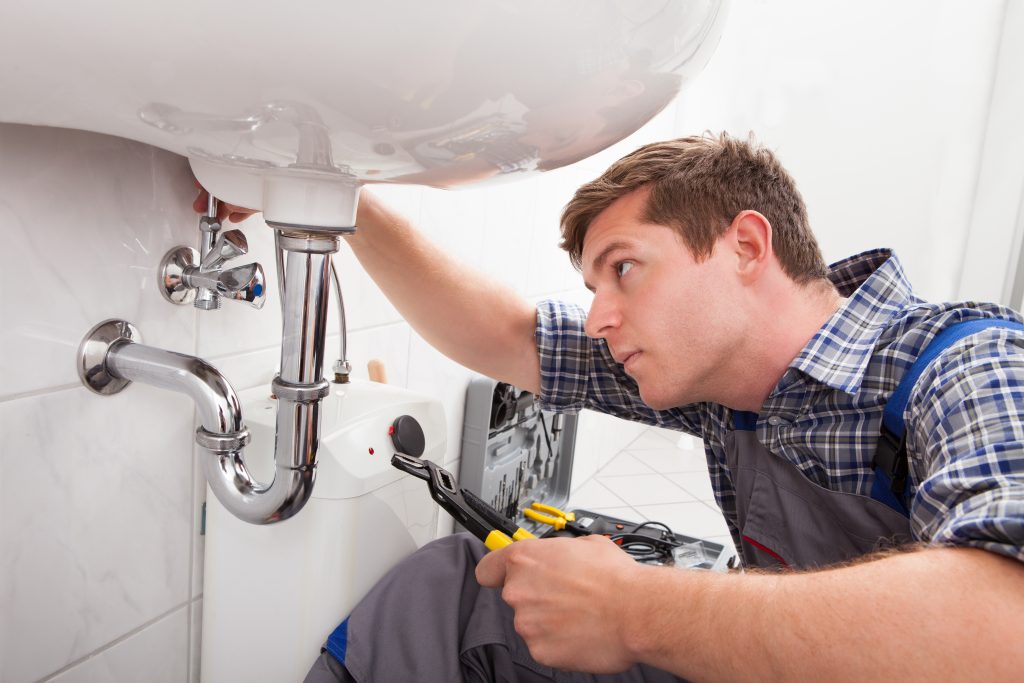 Plumber,Fixing,A,Sink,In,Bathroom