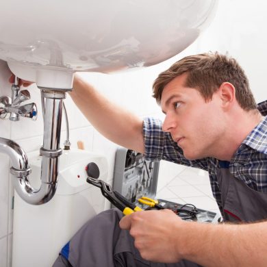 Plumber,Fixing,A,Sink,In,Bathroom